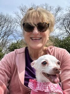 Nan Wise smiling with her dog Jilly, reflecting on pet loss grief